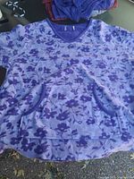 Floral fleece top laid flat showing pattern and pocket