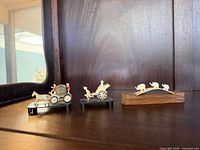 Full view of all three miniature figurines on shelf
