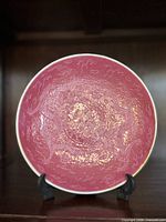Front view showing pink sgraffito dragon design