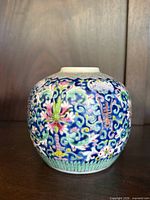 Front view showing floral and scroll decoration of ginger jar
