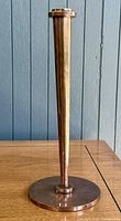 Full view of tapered copper bud vase standing upright