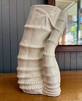 Front view of white porcelain bamboo-form vase