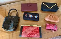 All seven purses and wallets laid out