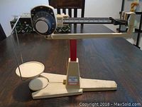 Full view of the Ohaus Dial-O-Gram balance scale showing the base, weighing pan, and the measuring arm.