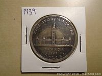 Front side of 1939 Canadian silver dollar showing the Canadian Parliament building, year, and inscriptions.