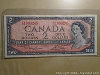 Front of the 1954 Canadian two dollar bank note showing Queen Elizabeth II portrait, denomination and serial numbers.