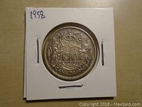 Reverse side showing the Canadian Coat of Arms, date 1958 and 50 cents denomination