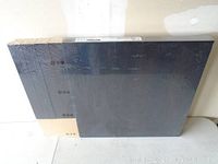 IKEA LACK black side table panels packed in original shrink wrap plastic.