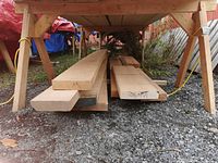 Stack of rough-sawn 8/4 maple boards under shelter