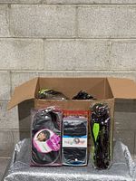 Box containing multiple individually wrapped black wigs with three sample packages displayed