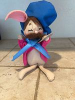 Front view of felt mouse doll showing hat, jacket, ribbon and spoon