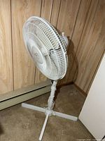 Side view showing full pedestal fan with base and head