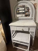 white wicker vanity with stool and mirror