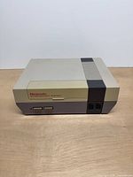 Front view of Nintendo NES-001 console showing power and reset buttons, controller ports, logo