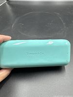 Front view of Tiffany blue hard eyeglasses case with embossed logo