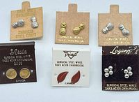 All six earring cards laid out, showing designs and packaging
