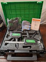 Full kit inside carrying case showing two arm jacks, gloves, manual, accessories