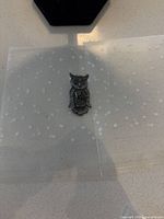 Front view of owl brooch pin