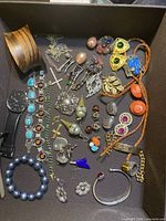 Full lot overview in box showing all jewelry pieces and watch