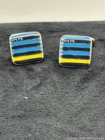 Full view of both square striped cufflinks