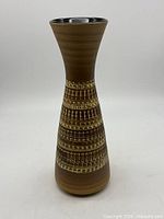 Full view of tapered brown ceramic vase