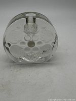 bottom view showing textured relief and flat polished base
