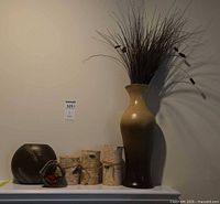 Full grouping showing tall vase with grasses, birch candle holders, carved vase