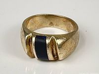 Front view of sterling silver ring showing black onyx inlay and angular shoulders