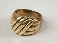 Front view showing ribbed diagonal swirl design and domed shape