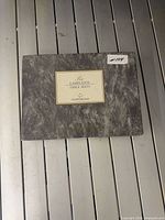 Closed grey Cloverleaf box top view showing label