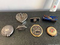 All seven vanity items closed, showing decorative lids and shapes