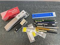 Overall view of staplers, staples box, ruler, pens and refills