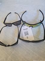 All four sunglasses laid out on surface