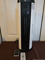 Front view of Omni Max tower heater and remote