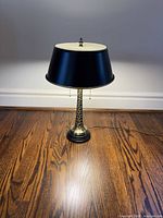 Full view of table lamp standing on floor showing shade and base
