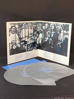 Gatefold open showing inner artwork and both records in translucent sleeves