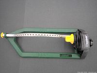 Top view of Melnor oscillating sprinkler showing spray tube and housing