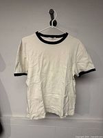 Front view of off-white Zara ringer T-shirt hanging on hanger