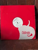 Front of Chiltepín Música sleeve with centre hole exposing record label