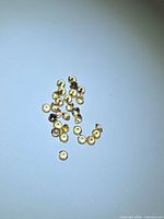 Group of small round champagne sapphires on blue surface
