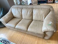 Full view of light tan leather 3-seat sofa