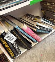 Shelf with music books including The Ultimate Pop/Rock Fake Book and others plus stack of magazines