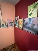 All seven canvases displayed on wall ledge