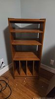 Front view showing three adjustable shelves and four lower compartments