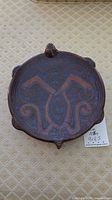 Top view of round brown and blue patterned ashtray