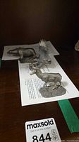 All three pewter figurines displayed on shelf