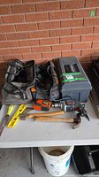 Overall lot showing drill, AutoTape, level, hammer, chisel, soft bag, hard toolbox