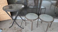 Set showing folding bistro table and two side tables on patio