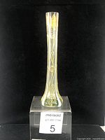 Full front view of tall blown glass bud vase showing shape and color gradient