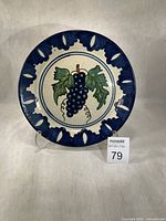 Front view of plate showing border and central grape design